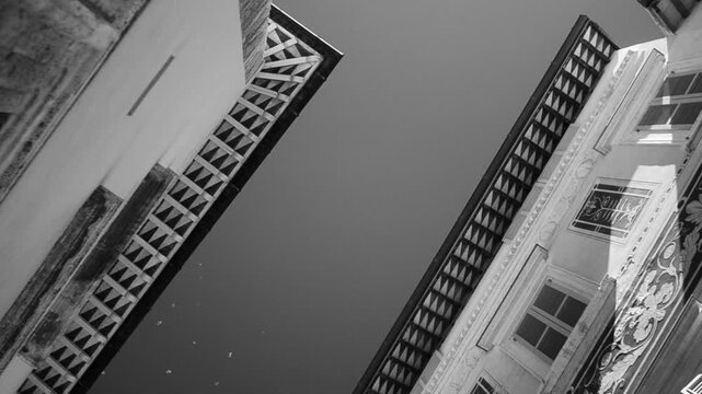 Low angle infrared view of building frescoes and flying birds