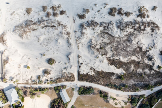 Jekyll Island, Georgia, United States - 31 December 2021: Aerial view of Jekyll Island sand dunes, coastal vegetation, and a sandy path leading to the beach.