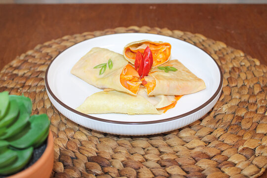 Traditional Indonesian spicy seblak basah folded crepe served on white plate