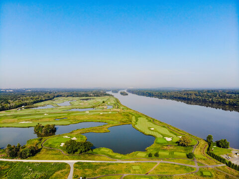 Sterling, Virginia, United States - 02 September 2018: Aerial view of Algonkian Regional Park featuring a lush green golf course situated along the banks of the Potomac River.