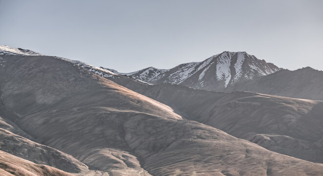 Rocky mountain slopes in the Pamir Mountains in Tajikistan, a minimalist landscape and rocky hills in sunny weather