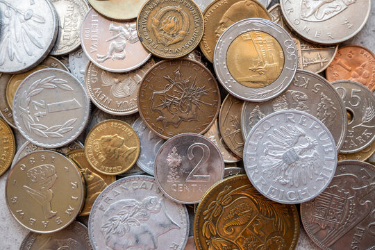 Pile of gold and silber coins on the natural background.