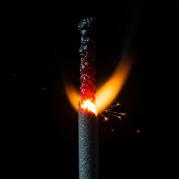 Extreme close up of a small, intense thermal burn mark left behind by a hot celebratory sparkler. Evidence of dangerous high heat, extreme, ember, ash