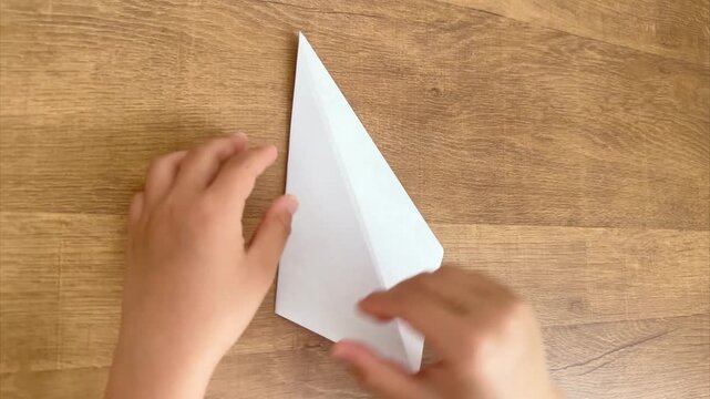 Child Hands Flip and Fold Up the Bottom Corner of Light Purple Origami, 4K
