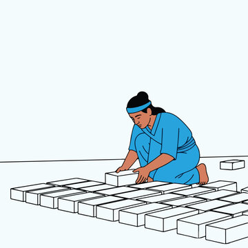 Person laying white blocks in neat rows on a flat surface