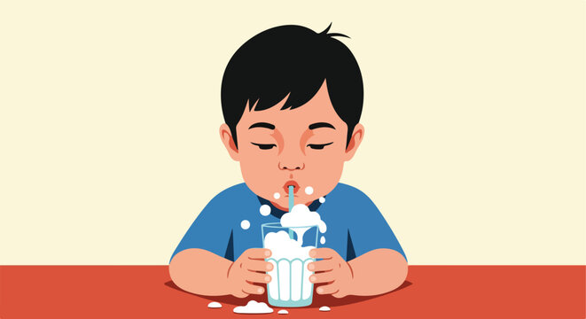 Young child drinks milk with a straw, spills some on table