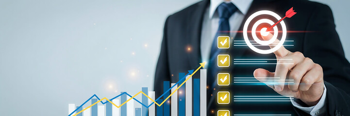 Businessman pointing at target with upward trending graph