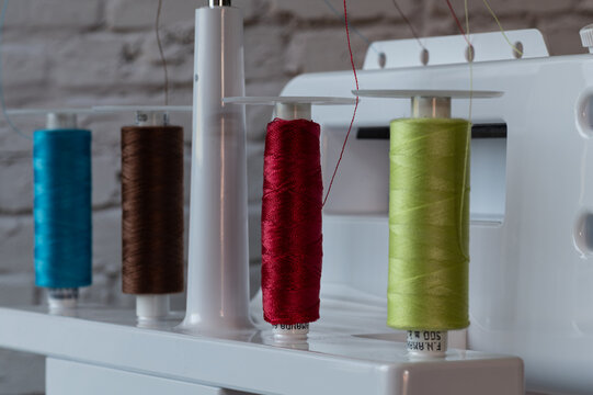 Overlock sewing machine, rear view with four fitted bobbins