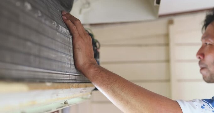 Mechanic man repair and clean air condition in city home diagnostic electronic industry