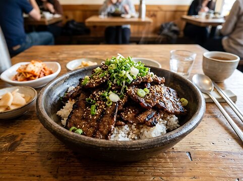 Delicious Korean BBQ Beef Bowl with Rice and Kimchi Served in a Cozy Restaurant Setting