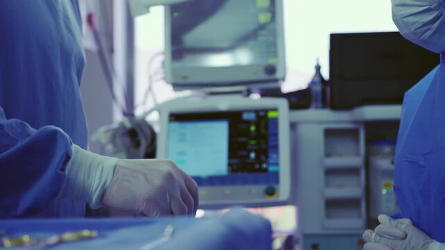 Doctor Working on Computer Monitor in Modern Hospital Operating Room with Advanced Medical Equipment and Healthcare Technology
