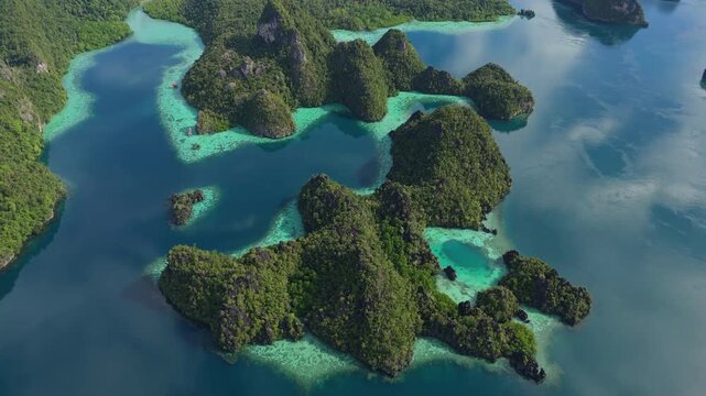 Breathtaking high angle panorama of untouched Misool coastline &ndash; Vivid turquoise water gradients, wild limestone islands and lonely beach sands, clean cinematic background asset for advertising
