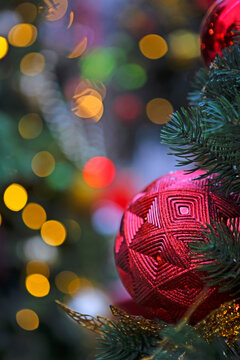 Red and gold balls on Christmas tree. Christmas decoration. Background for Christmas card. New Year's bokeh