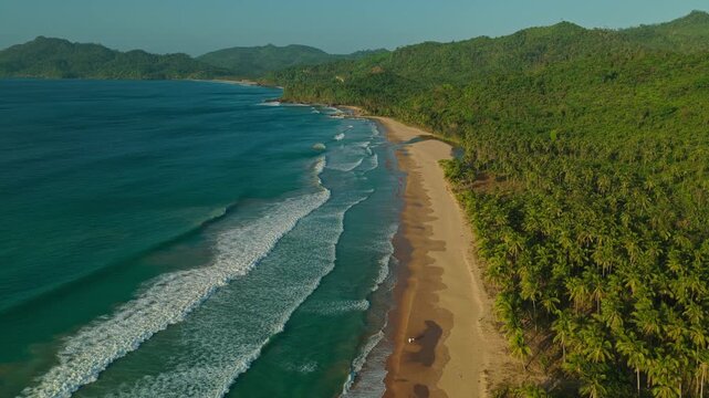 High Altitude Aerial Forward Tracking Shot Along Far End of Duli Beach in El Nido, Philippines. Drone View of Golden Sand Shoreline, River Estuary, Ocean Surf, and Jungle Canopy.