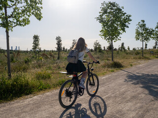 Fototapeta premium Woman riding electric bike in valdebebas park