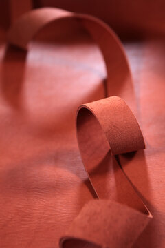 Piece of genuine leather for making belt. Leather workshop. Manufacture of straps made of genuine leather or suede. Workflow in workshop. Handmade work