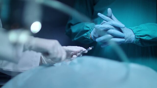 Surgeon Performing Life Saving Operation on Patient in Modern Hospital Operating Room with Medical Team and Advanced Surgical Equipment
