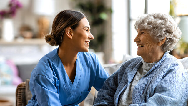 Professional nurse providing support and companionship to a smiling senior woman in a comfortable home environment, homecare and assisted living concept highlighting trust, healthcare, and quality.