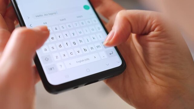 Female hands typing text on smartphone close-up.