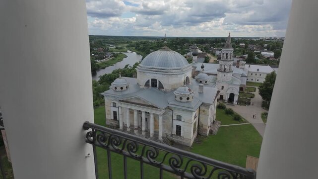 Perspective view between classical white columns against blue sky