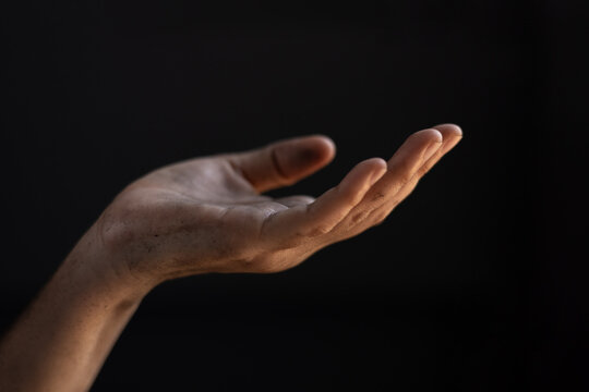Dirty hand in begging gesture. Poverty and humanitarian crisis