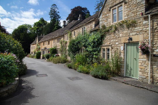 Cotswolds stone cottages lining historic castle combe village street