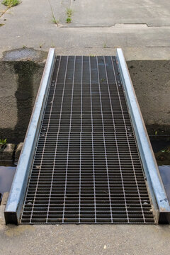 Steel grating crossing on river embankment