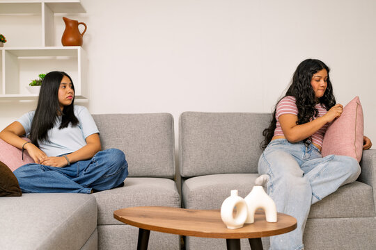 Two young women experiencing conflict or disagreement at home