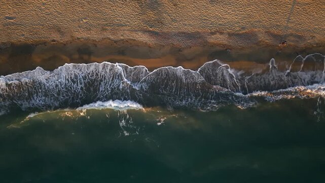 Aerial photography in 4K format &ndash; aerial view (ultra-high resolution) of sunset or sunrise on the seashore. Reflection in the water. Beautiful summer seascape of the Mediterranean Sea. Background 