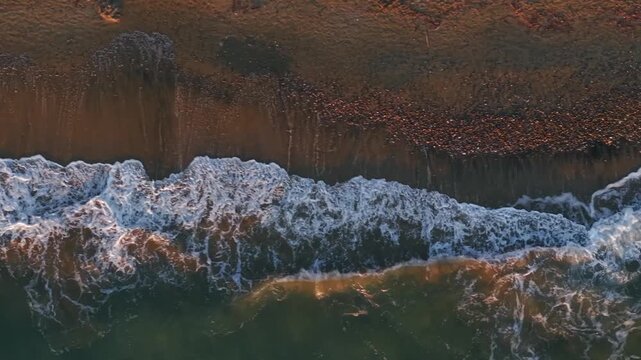 Aerial photography in 4K format &ndash; aerial view (ultra-high resolution) of sunset or sunrise on the seashore. Reflection in the water. Beautiful summer seascape of the Mediterranean Sea. Background 