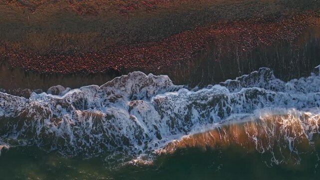 Aerial photography in 4K format &ndash; aerial view (ultra-high resolution) of sunset or sunrise on the seashore. Reflection in the water. Beautiful summer seascape of the Mediterranean Sea. Background 
