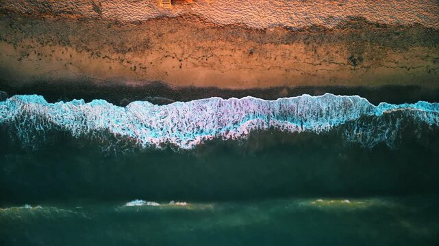 Aerial photography in 4K format &ndash; aerial view (ultra-high resolution) of sunset or sunrise on the seashore. Reflection in the water. Beautiful summer seascape of the Mediterranean Sea. Background 