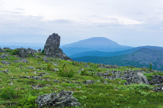 Mountain landscape with green grass and rocks. Urals.
