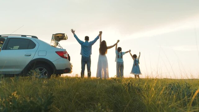 happy family traveling by car, father mother child kid girls daughters raise hands sunset, child holding mother hand, child holding father hand, family traveling by car, road riding car sister, hand