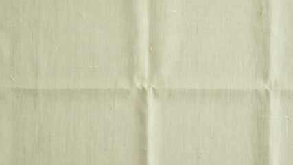 Fototapeta premium Wrinkled beige fabric texture, creased cloth background, neutral colored linen, folded material