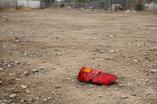 A red object sits in the middle of a dirt field, surrounded by nothingness