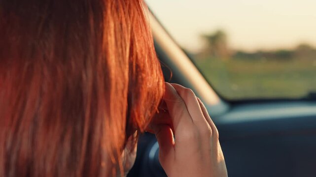 young girl eats hamburger while sitting car seat, girl face touches hamburger close-up, trip vacation holiday, driving along road trip, happy man eats appetizing hamburger while sitting front seat by
