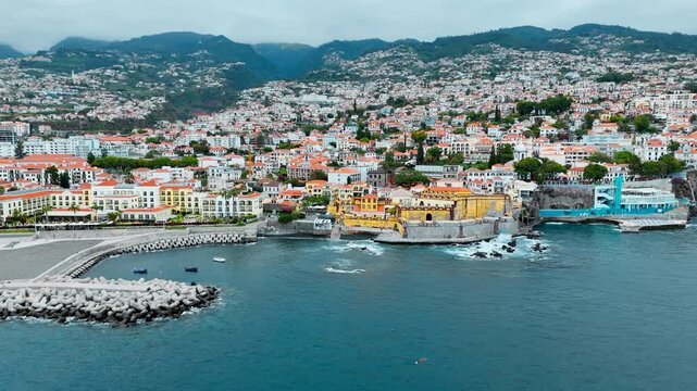 Aerial coastal view of Fortaleza de Sao Tiago with city buildings and harbor area in Funchal, Madeira, Portugal