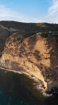Coastal Cap Canaille rock formations along coast of Mediterranean sea in Cassis, southern France, Aerial drone shot from sea