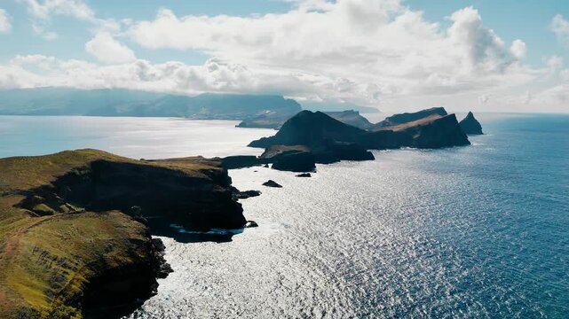 Rocky coastline of Sao Lourenco Peninsula, Madeira Island, Atlantic Ocean. Aerial drone view of volcanic cliffs and deep blue water