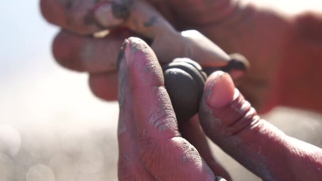 Clay craft hands molding small object outdoors, traditional art skill creative process
