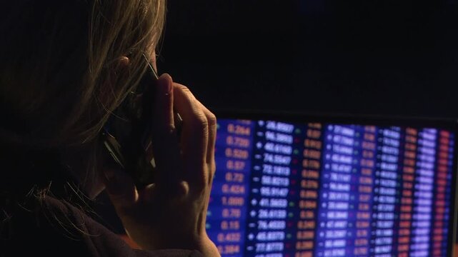 A financial analyst looks at a computer screen. A cryptocurrency specialist.