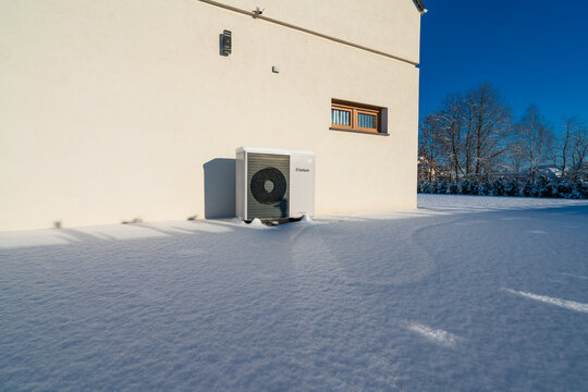 Vaillant Arotherm Plus heat pump covered in snow on sunny winter day.  Vaillant is a renowned German heating manufacturer offering advanced, energy-efficient heat pump systems