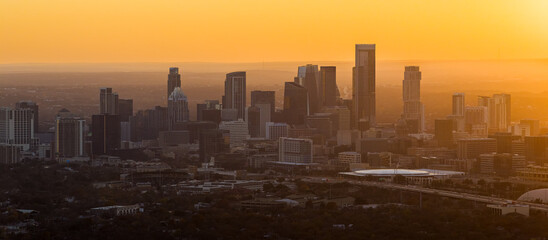 Aerial view of downtown Austin Texas skyline glowing at golden sunset © Thomas