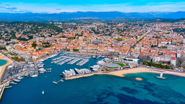 Aerial drone view of Cannes Old Port Vieux Port marina with superyachts, Palais des Festivals et des Congr&egrave;s and La Croisette beach, C&ocirc;te d'Azur, France, summer