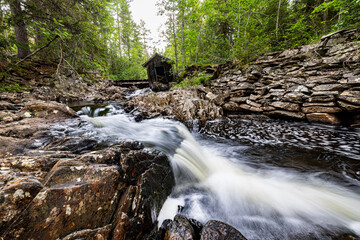 Water rushes over jagged rocks, creating frothy white cascades © Tobben-PHOTO