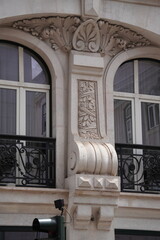 Ornate Neoclassical Building Facade with Carved Stone Arch, Scrollwork and Ironwork Balconies, Lisbon © helen
