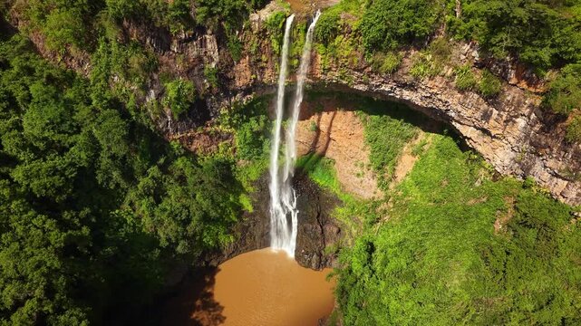 Aerial view of a majestic Chamarel waterfall cascading into a tropical jungle pool