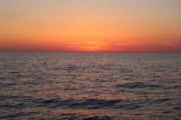 Fototapeta premium Sea sunset with orange sky