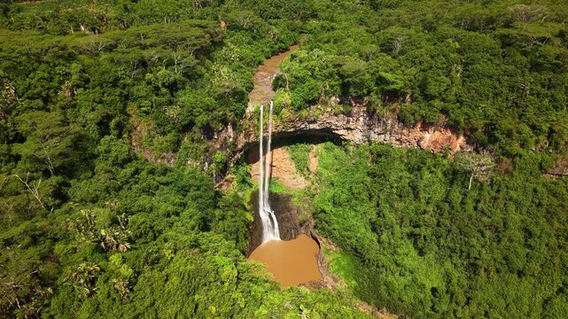 Aerial view of Chamarel waterfall in Mauritius surrounded by lush tropical forest